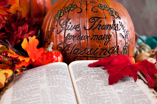 Thanksgiving pumpkin and open Bible to Psalms