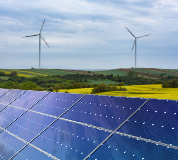 istock Solar panels and wind turbines in a field 1732053777