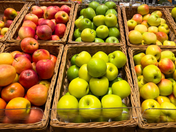 istock Apples in wicker baskets on a store counter. 1732055526