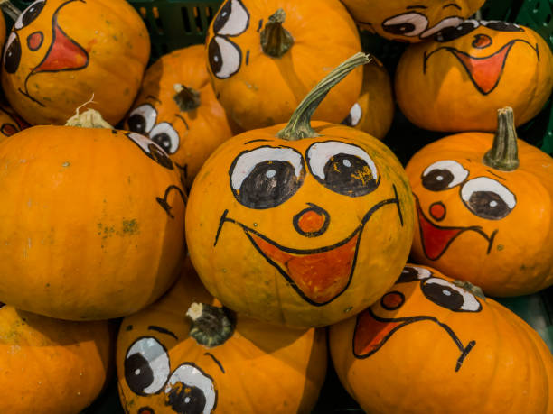 istock Pumpkins with a painted smiling face and cheerful eyes. 1732059258
