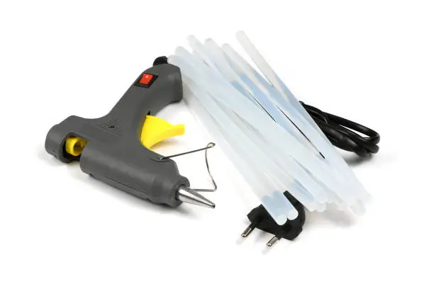 Electric hot glue gun with gluestick isolated on white background. High resolution photo. Full depth of field.