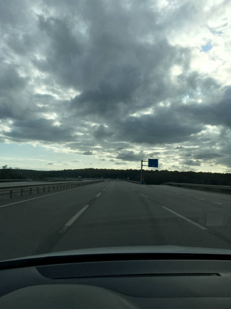 istock Driving on highway road with cloudy sky 1732062846
