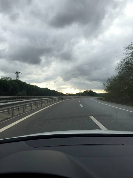 istock Driving on highway road with cloudy sky 1732063984