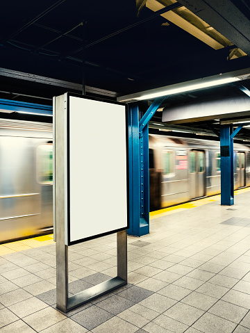 Illuminated blank digital billboard in underground train station in New York City