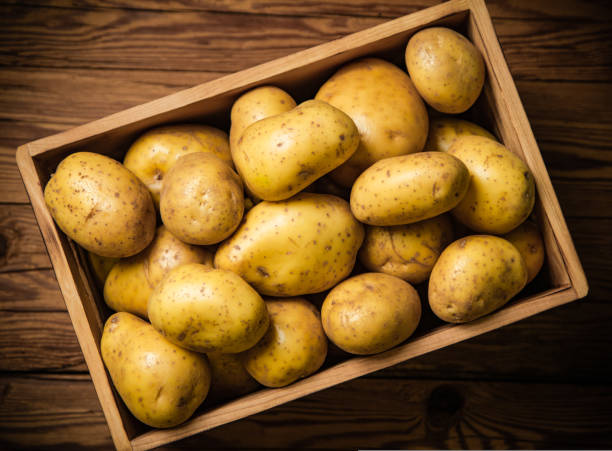 istock Fresh potatoes. On wooden table. 1732071255