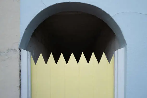 Photo of Improvised house gate with sawn sharp edges to help prevent intruders.