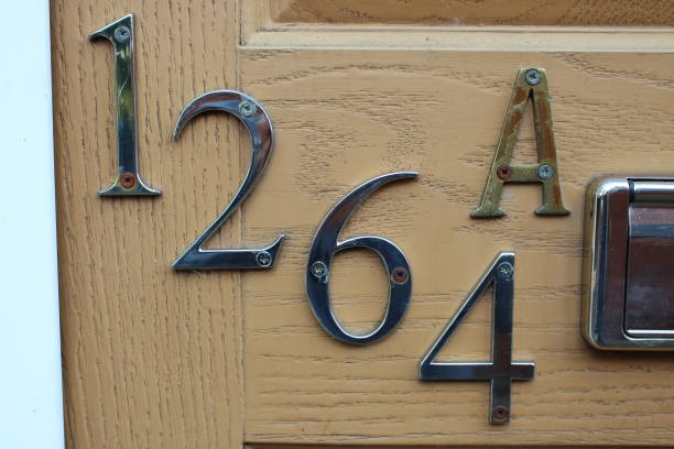 istock House numbers 1264 A attached to brown door UK 1732094109