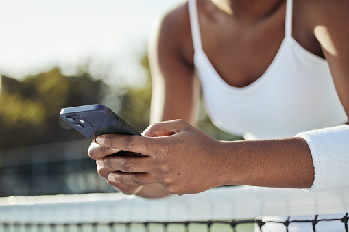 Tennis, woman hands and phone text outdoor for sport, fitness and workout with social media at net. Exercise, match training and mobile networking with website and online app on court for wellness