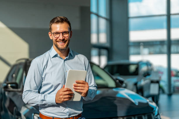 istock Professional salesman working in car dealership 1732096312