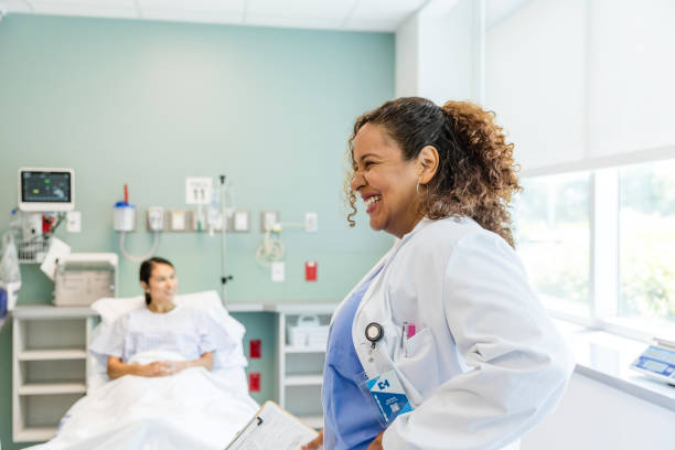istock Female doctor laughs while speaking to her unseen colleagues 1732097944