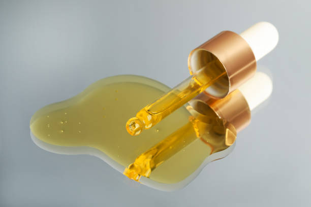 istock Yellow serum with pipette on mirror, closeup 1732110994