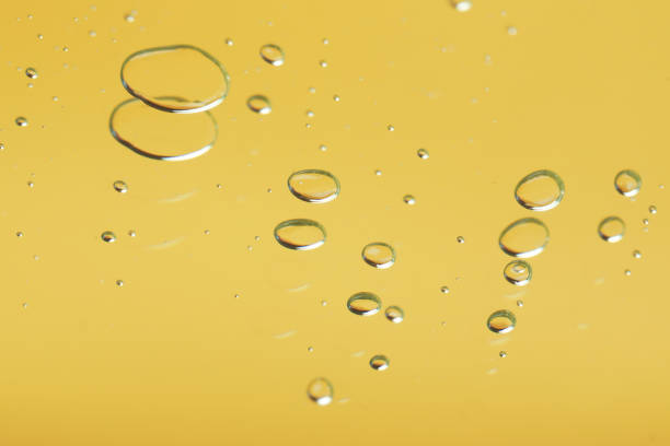 istock Many serum drops on mirror, toned in yellow 1732111522