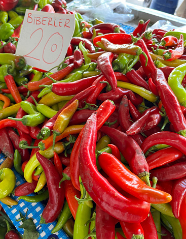 Hot red and green chili peppers on market stall
