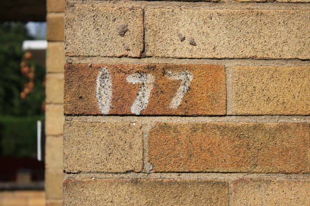 istock Numbers 177 painted onto a brick house 1732183041