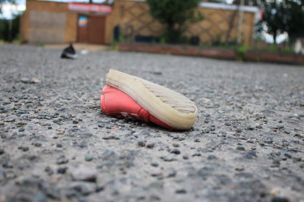 Discarded children's pink shoe upside down in a public space