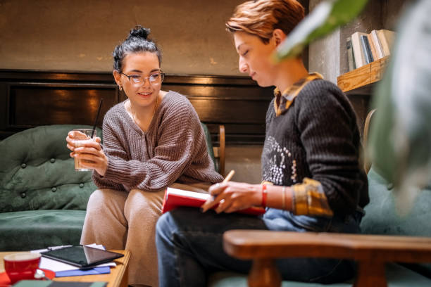 istock Female college students spending time studying together in coffee shop 1732186736