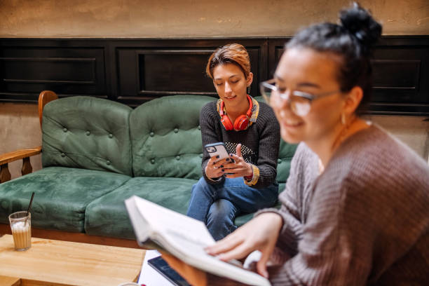 istock Female college students spending time studying in coffee shop 1732187307