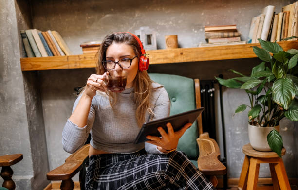 istock Young beautiful woman taking a break in coffee shop and using a digital tablet 1732188334