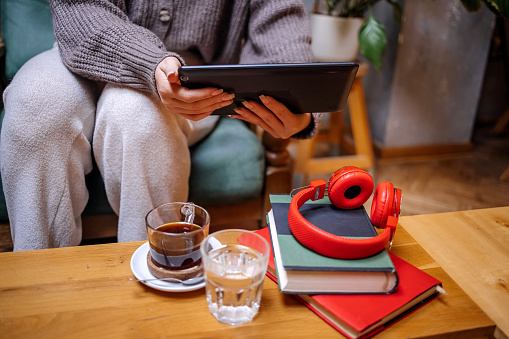 Young woman having a coffee break with using digital tablet