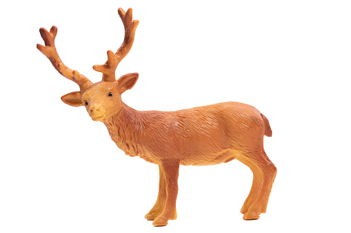 An isolated toy deer in profile looking at camera on a white background. Big horns.