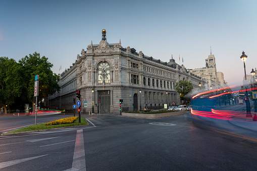 Image of the facade of the Bank of Spain early in the morning with traffic around it on a summer day in the Spanish capital. Madrid. Spain.  July 28, 2023.