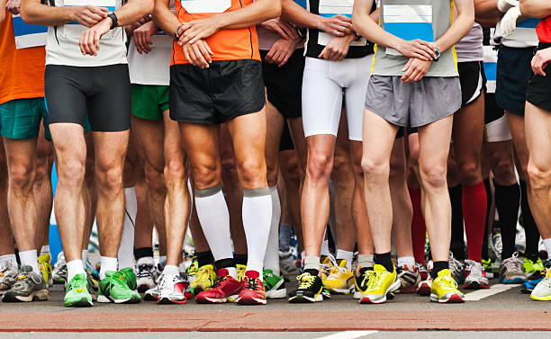 Legs of athletes before marathon start.