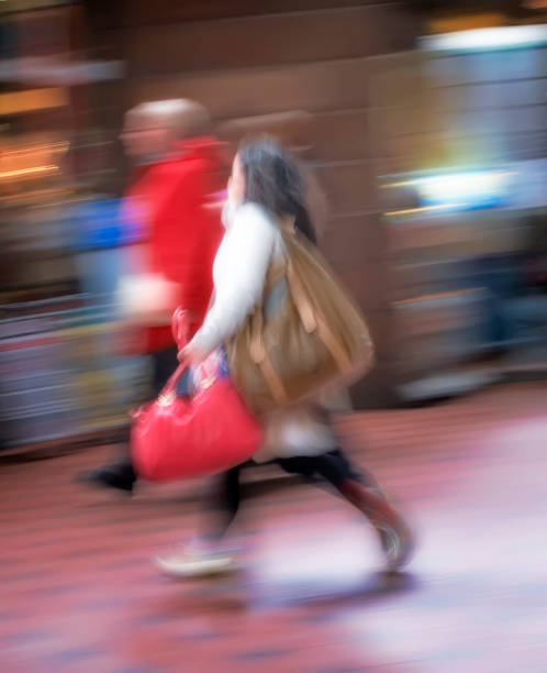 A motion and lens burred image of people moving