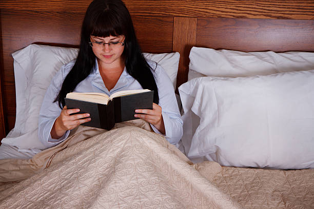 istock Young Woman Reading In Bed 173228307