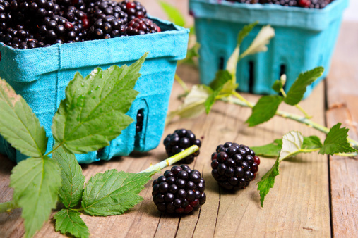 Boxes Of Blackberries With Leaves On Wood