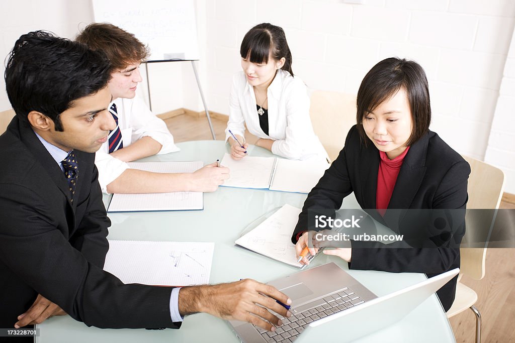 Young business people A group of four young business people, working together.  Adult Stock Photo