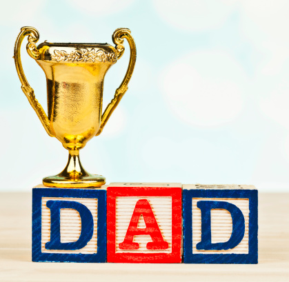Blocks spelling dad, with gold trophy, for Father's Day