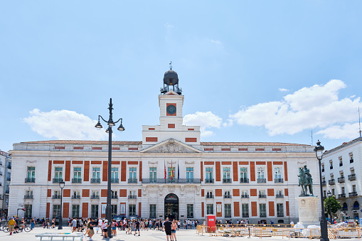 Madrid, Spain - July 19, 2022: Facade of the Royal Palace. The old building is a major tourist attraction in the Spanish capital city.