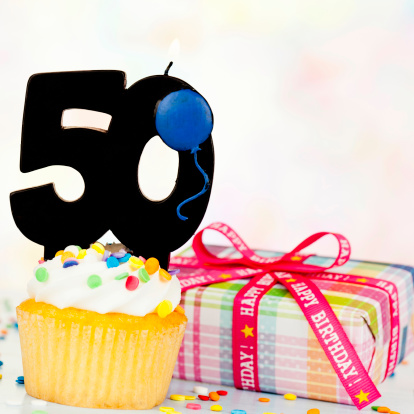 Cupcake with 50 candle with birthday gift