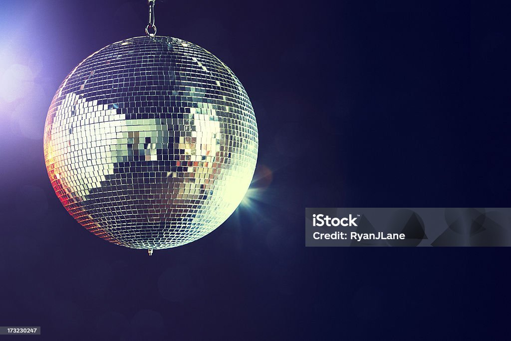 Disco Ball A shining disco ball glitters and spins in a dance club at night, reflecting the various colored lights.  Horizontal with copy space. Disco Ball Stock Photo