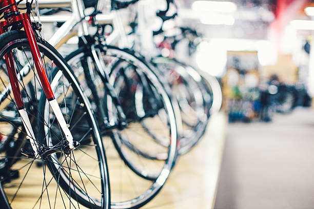 Bicycle Shop A row of new bicycles sitting in a shop. View of front wheels and tires. Horizontal with copy space. Selective Focus. bicycle shop stock pictures, royalty-free photos & images