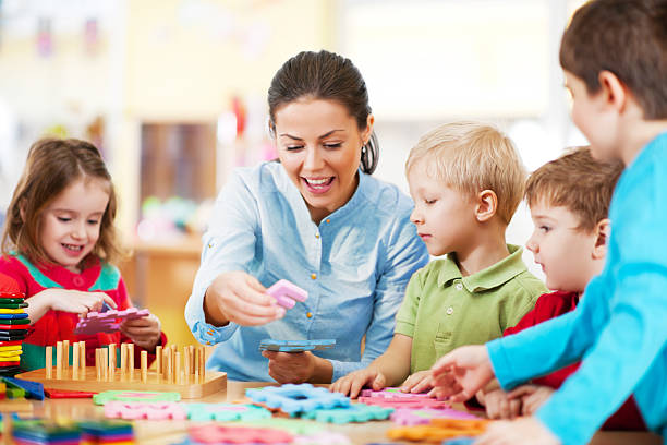 istock Nursery teacher playing with the kids 173230386