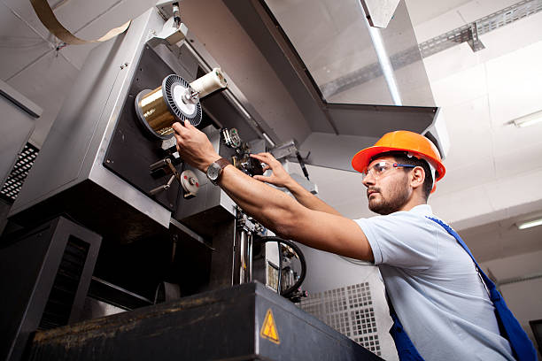 Young Foreman Young manual worker working in factory. machine stock pictures, royalty-free photos & images