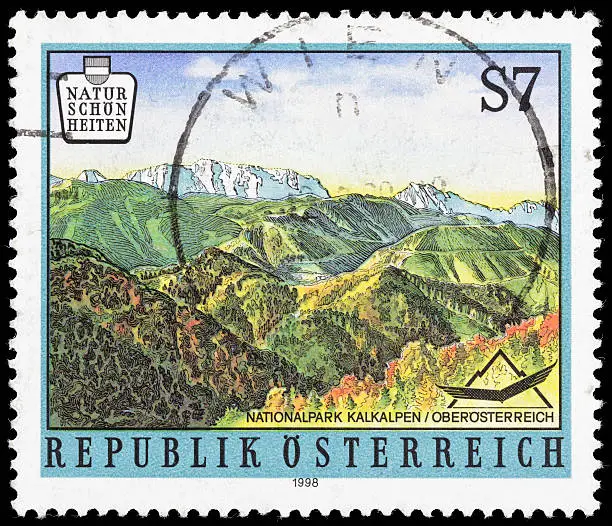 A 1998 Austria postage stamp with an illustration of a landscape scene within Kalkalpen National Park in Upper Austria; postmarked in Vienna (Wien).