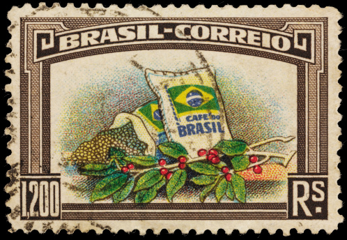 1937 Brazil postage stamp with an illustration of two bags of Brazilian coffee beans and a branch of a coffee plant with ripe coffee beans.