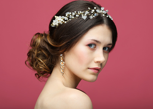 jewelry, luxury, wedding and people concept: young bride with gorgeous diadem in her hair