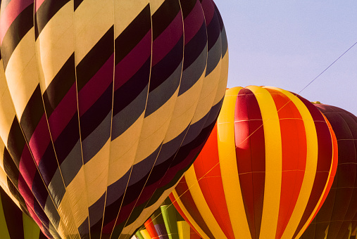 Low angle view of small group of hot air balloon preparing for takeoff.\n\nTaken in Reno, Nevada, USA