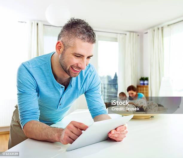 Happy Man With Tablet At Home Stock Photo - Download Image Now - Home Interior, Laptop, Turquoise Colored