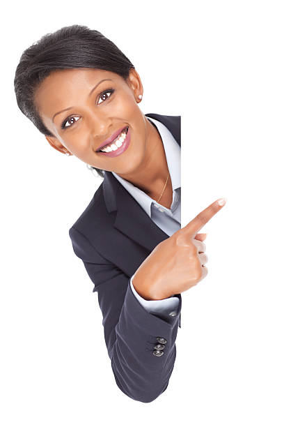 donna d'affari che punta su spazio vuoto cartellone. - advertisement advertise businesswoman peeking foto e immagini stock