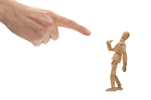 istock A hand pointing at a wooden mannequin 173234007