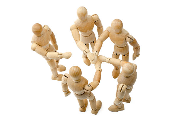 istock all for one - Wooden mannequin putting hands together 173234042