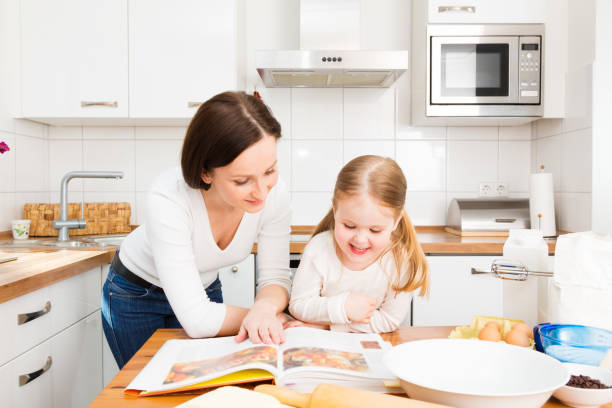 mother and daughter baking cookies