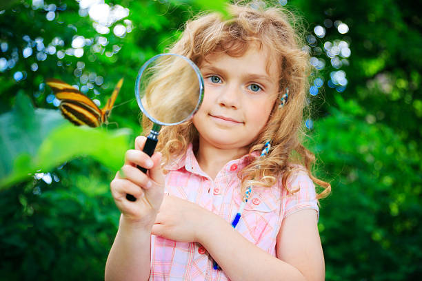 istock little girl watching butterfly 173234335