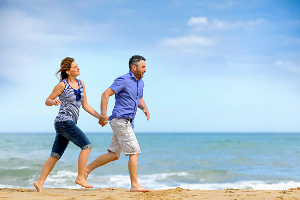 istock couple running on beach 173234999