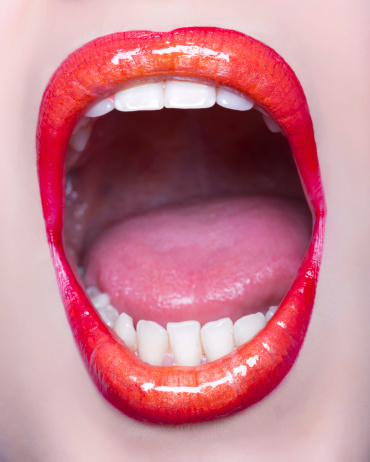 young woman mouth screaming,red and orange lipstick.