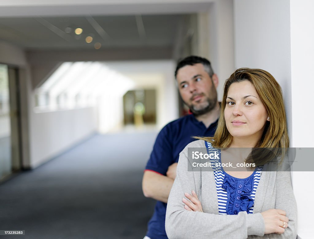couple issues young couple indoors shoot with arms crossed posing. 20-29 Years Stock Photo